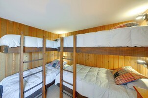 A bunk bed room with wooden walls and a ladder.