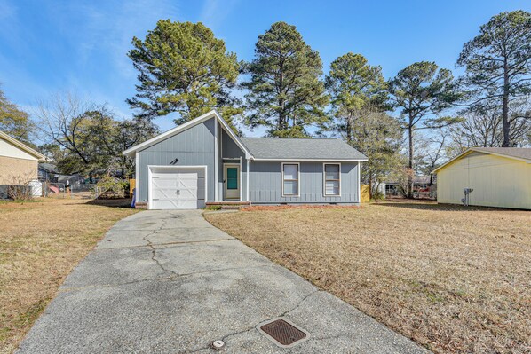 A single-story house with a garage, a front yard, and a small porch. - Quiet & Modern Family Home in Spring Lake (Spring Lake)