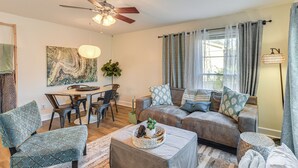 A living room with a sofa, chairs, a coffee table, and a dining area with a table and chairs. - Quiet & Modern Family Home in Spring Lake (Spring Lake)
