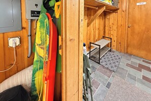 A wooden interior with a bench, a wall-mounted electrical box, and a door with a sign. - 7 Mi to Mount Snow Cozy 4BR Mountain Retreat (West Dover)