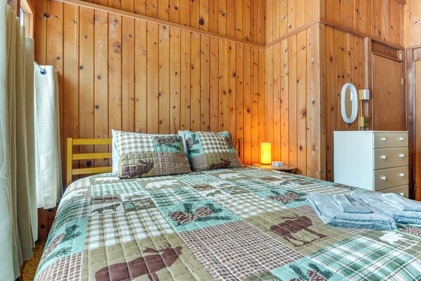 A wooden-paneled room with a bed, a nightstand, a dresser, and a mirror. - Ski Weekends in West Dover, 7 Mi to Mt Snow (West Dover)