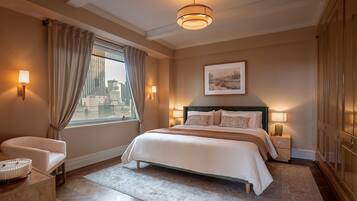 A hotel room with a large bed, a sitting area with a chair, a view of the city, and a large wardrobe.
