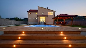 A house with a swimming pool, wooden deck, and outdoor seating area. - Villa Julija (Vodice)