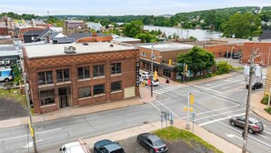 A street view with a prominent brick building labeled "Millrows."