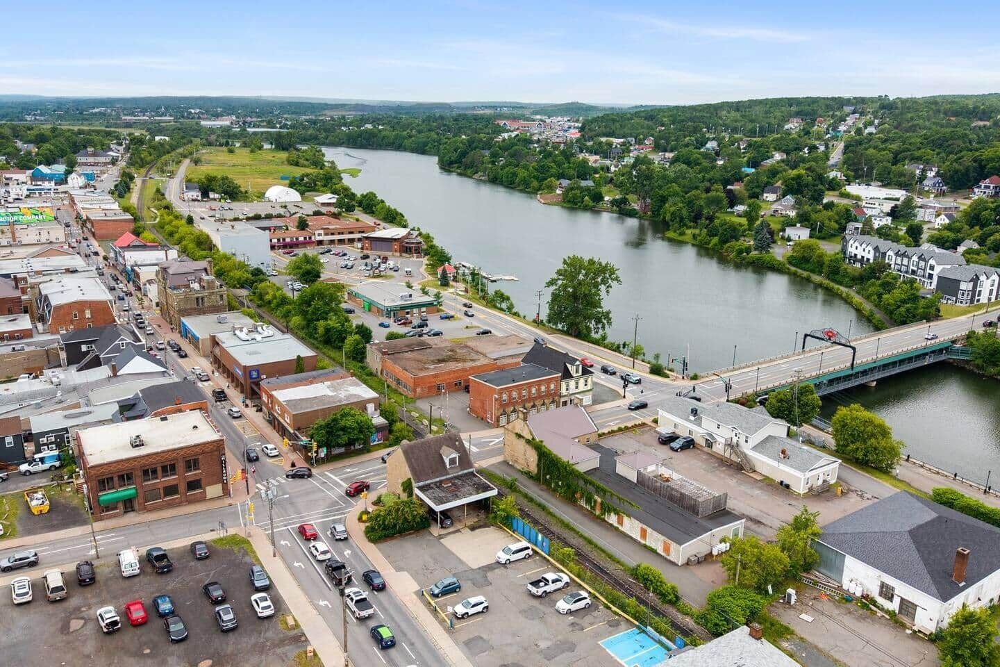 A town with a river, buildings, and a bridge.