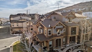 A multi-story residential building with a driveway and a small garden area. - Modern Mountain Home Near Park City & Jordanelle (Kamas)