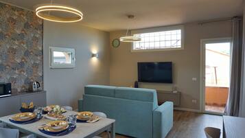 Deluxe Apartment, Lake View | Living area | 50-inch flat-screen TV with digital channels, heated floors