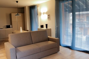 Comfort Apartment | Living area | 50-inch flat-screen TV with digital channels, heated floors - Borgo Predeschera (Lonato del Garda)