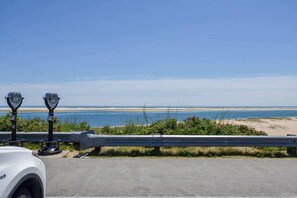 A coastal view with a paved walkway, metal barriers, and two vintage telescopes. - Dog Friendly, Game Room, Central AC! (Chatham)