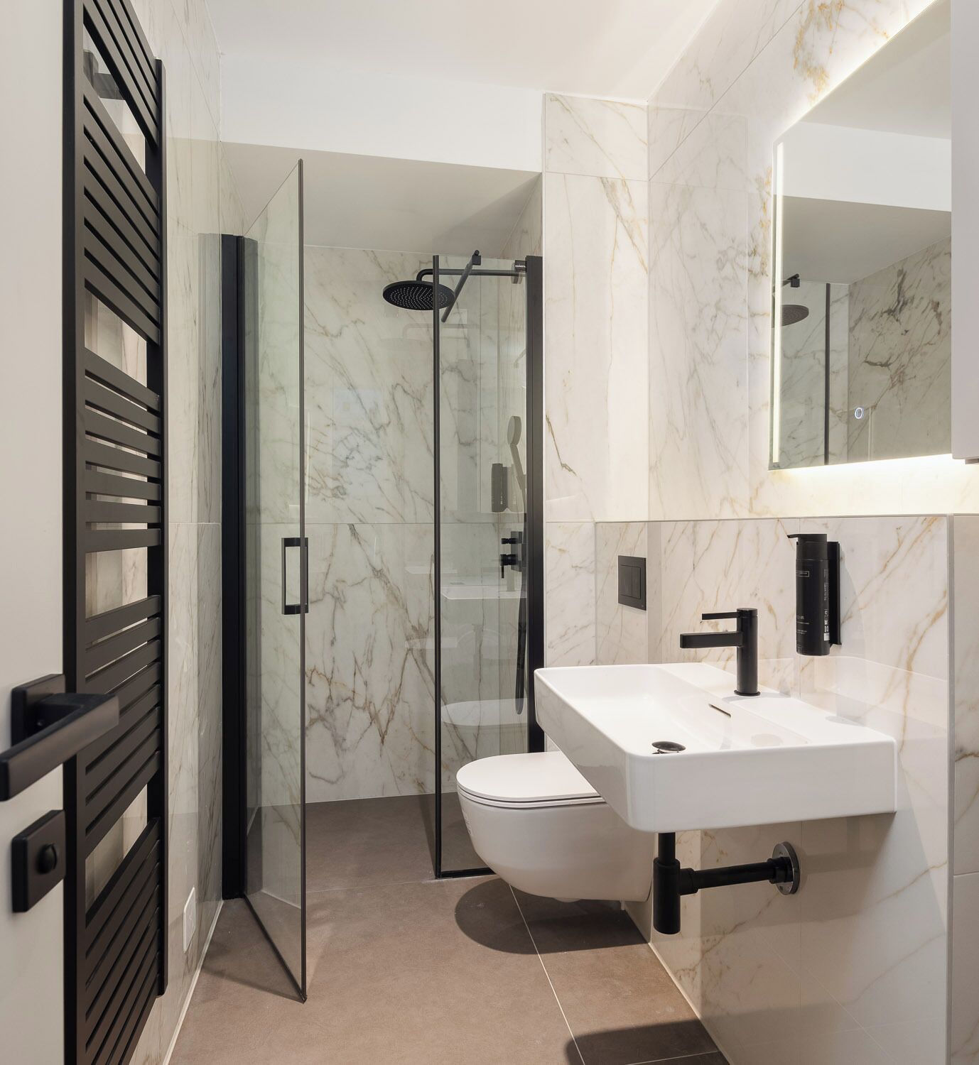 A modern bathroom with a glass shower enclosure, a white sink, and a large mirror.