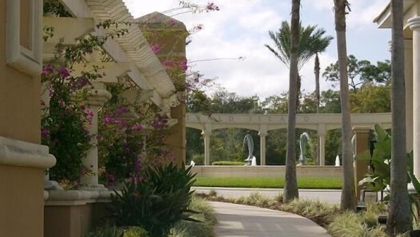 A pathway leading to a covered area with columns and a fountain. - Luxury Resort Townhome- 3 miles to Disney- Low Price- Online Booking (Kissimmee)