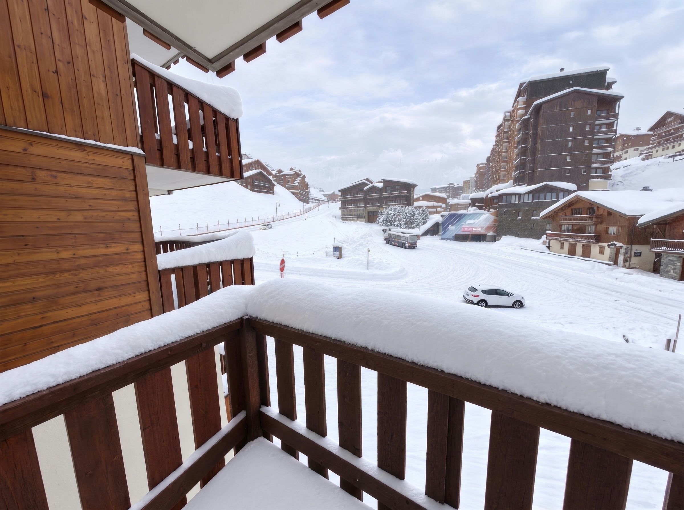 A snowy mountain town with wooden buildings and a snow-covered street.
