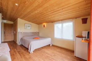 A bedroom with a wooden ceiling, a bed, a small desk, and a window. - Guest Room 'Gorges de l’Ardèche' with Shared Pool, Wi-Fi, and Air Conditioning (Saint-Remèze)