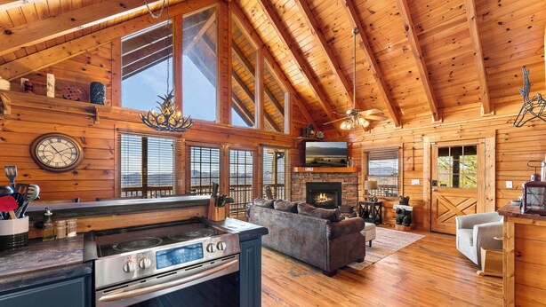 A spacious log cabin with a large kitchen, a cozy living area, and a fireplace. - Edge of Glory Cabin | Views | Hot Tub | BBQ (Pigeon Forge)