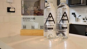 Two bottles of water labeled 'andea' on a counter with a sign for 'DESCUBRE PERÚ' in the background. - w* | Engaging Loft in the Heart of San Isidro (San Isidro)