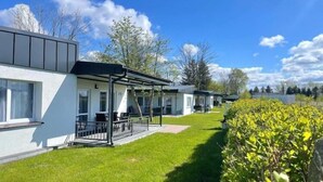 A row of modern, white buildings with flat roofs and large windows, likely part of a hotel or resort. - Holiday home very close to the beach (Sianozety)