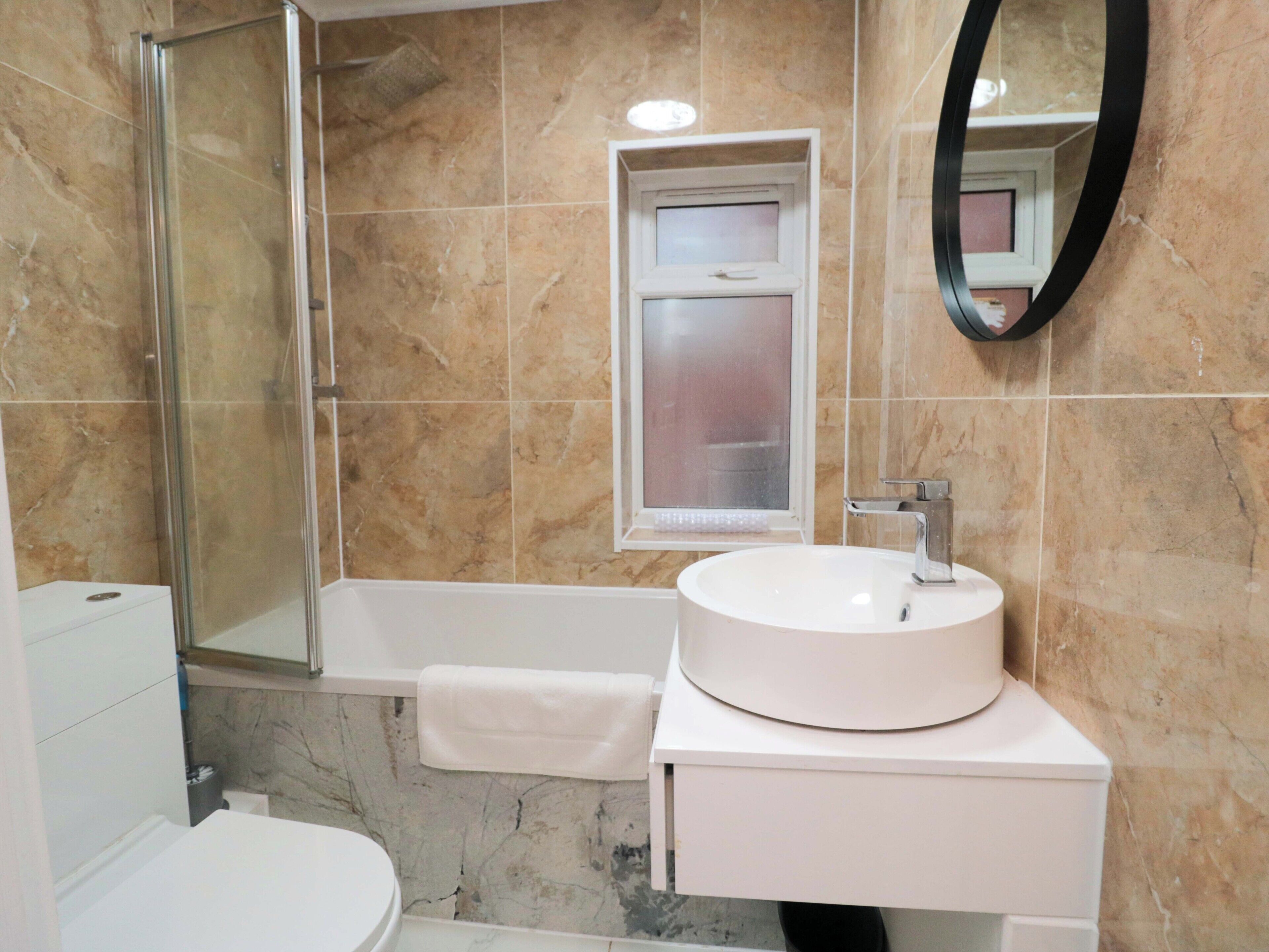 A bathroom with a bathtub, a sink, and a toilet.