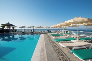 Seasonal outdoor pool, pool umbrellas, pool loungers