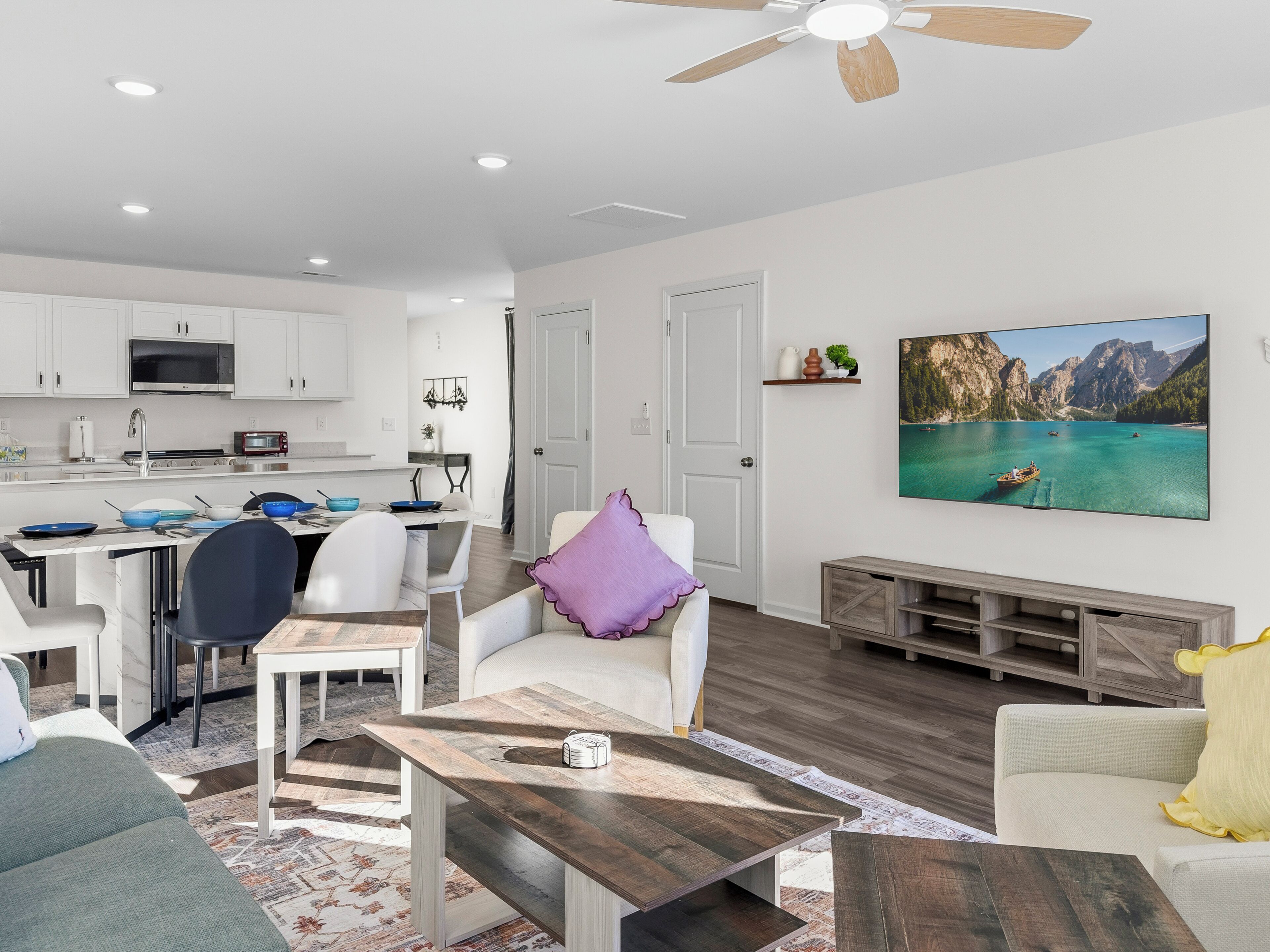 Un espacio habitable moderno con cocina, comedor y un amplio ventanal con vistas a la montaña.