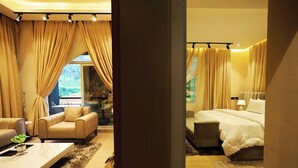 A hotel room with a sofa, a bed, and a view of the outdoors. - Iri Diplomatic Resorts (Abuja)