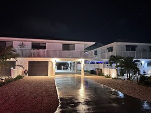 A modern two-story house with a covered driveway and a visible garage door. - Key Colony Beach Home Casa Sunny Sea Key Colony Beach, Fl Keys (Key Colony Beach)
