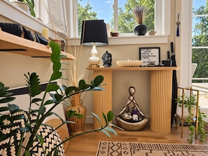 A room with a wooden shelf, a Buddha statue, a lamp, and a sign about rentals and activities. -  Lotus – Lakeview Glamping at Namastay Retreat, Shuswap Lake (Columbia-Shuswap)