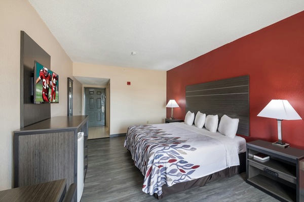 Unwind in a crisp king bed with streaming-ready TV.