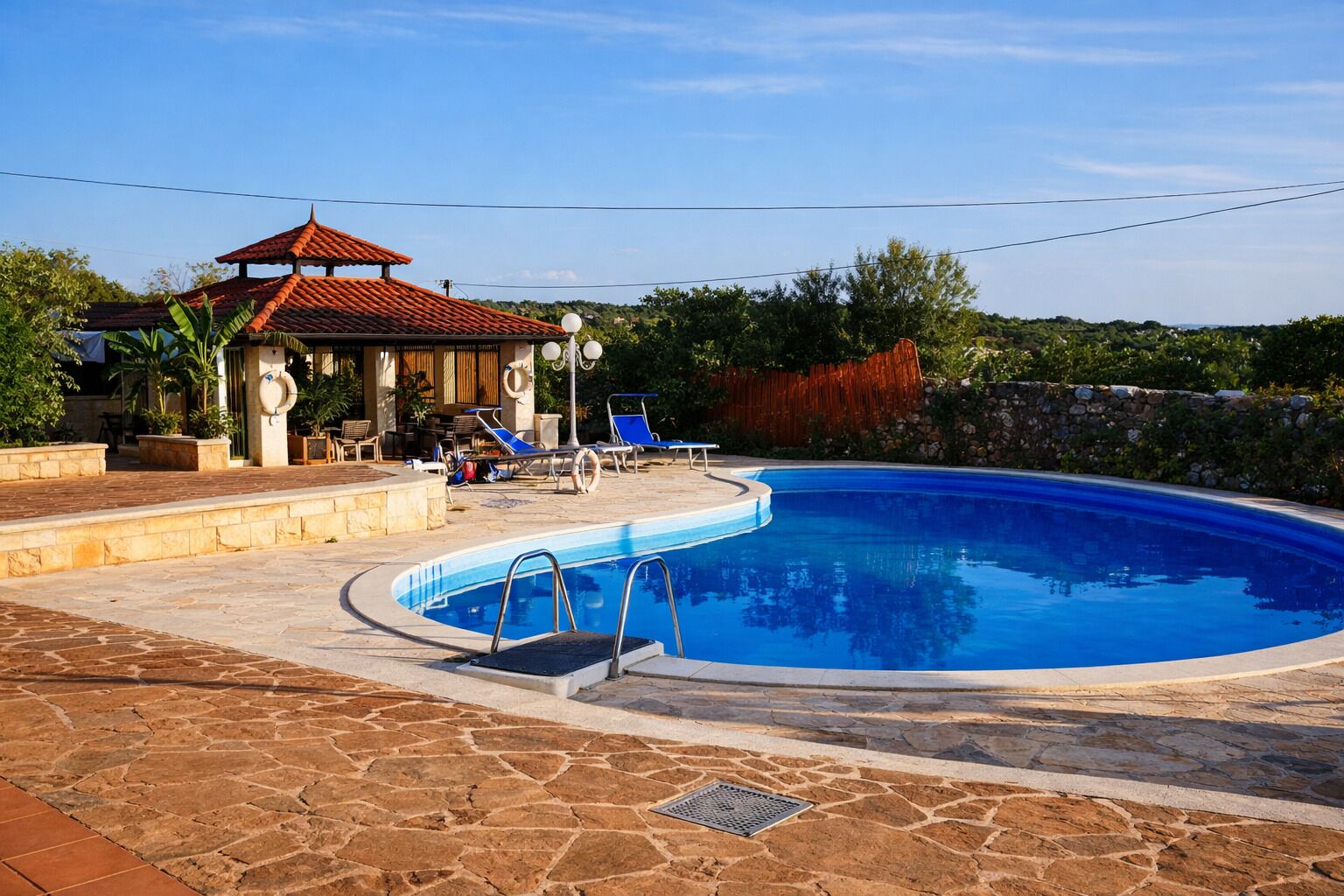 Seasonal outdoor pool, open 11:00 AM to 6:00 PM, pool umbrellas