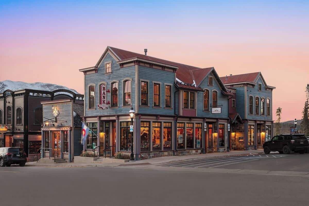 A historic building with a prominent bank sign, large windows, and a classic architectural style.