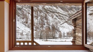 A window with a view of a snowy mountain landscape.