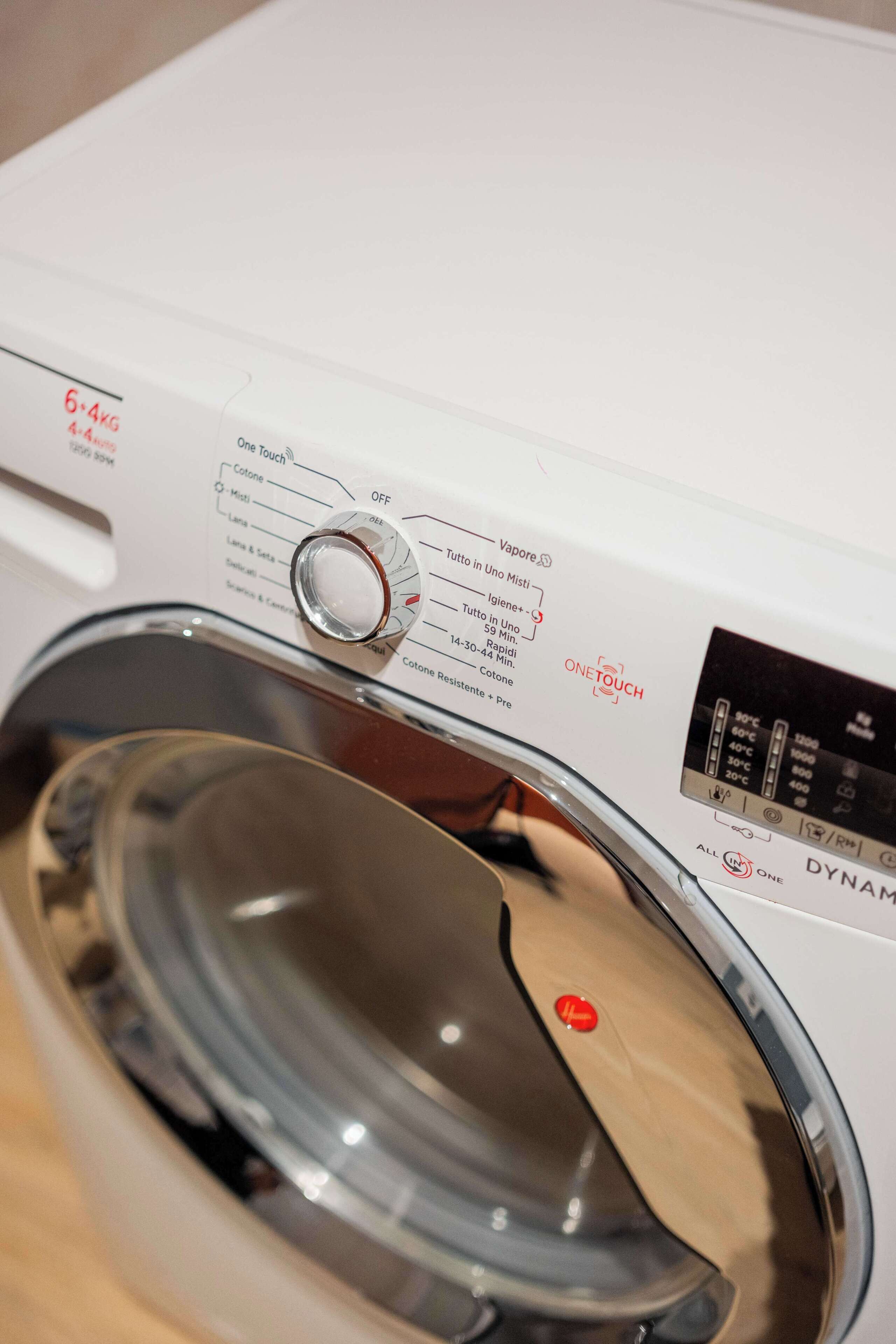 A front view of a washing machine with a control panel and a transparent drum.