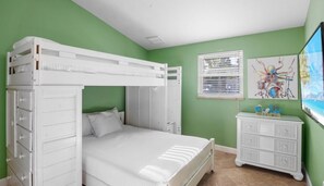 A bunk bed with a dresser and a painting on the wall. - AMI Sunset~Close to beach! Heated Pool! (Holmes Beach)
