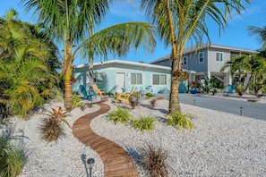 A house with a pathway leading to a door marked '155'. - Blue Heron Hideaway (Fort Myers Beach)