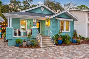 A two-story house with a front porch, a mailbox, and a number '410' on the door. - Amazing Heated & Screen Pool w/ Stunning Design! (Crystal Beach)
