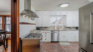 A modern kitchen with white cabinets, a stainless steel range, and a dishwasher. - Waterfront House w/ Patio Near Riverside Park (Kaukauna)