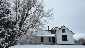 A white house with a gabled roof, a chimney, and a front porch. - New River Gorge National Park Sunsets, Rafting and Hiking trails. (Lansing)