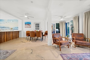 A spacious living area with a dining table, several chairs, and a seating area with two sofas. - Aurora Breeze Estate - The Heart of Matlacha Living (Matlacha)