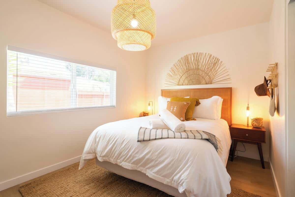 The warm and inviting master bedroom with a luxe queen bed