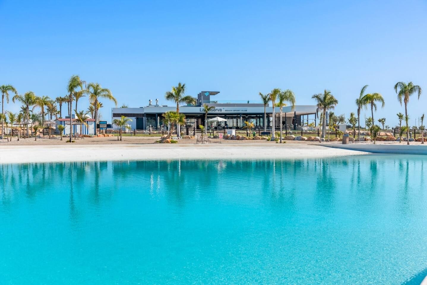 A resort with a pool, palm trees, and a building labeled 'Lansiverra Beach Resort Club'.