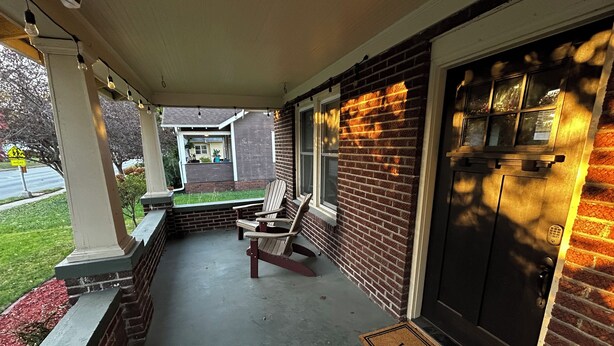 A porch with two Adirondack chairs, a welcome mat, and a door with a keypad lock. - 2 Bdrm home close to downtown Ames, Jack Trice, Hilton Coliseum & Stephens (Ames)