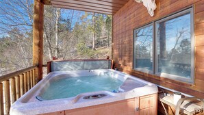 A wooden cabin with a hot tub, a wooden deck, and a large window. - 1 Mi to Terry Peak! Black Hills Cabin Hideaway (Lead)