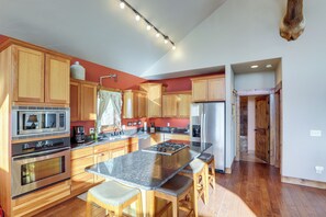 A modern kitchen with wooden cabinets, stainless steel appliances, and a granite countertop. - 1 Mi to Terry Peak! Black Hills Cabin Hideaway (Lead)