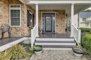 A stone house with a porch, a front door with a wreath, and two planters. - 2 Mi to Bethany Beach! Spacious Family Retreat (Ocean View)