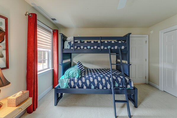 A bunk bed room with a ladder, a window with blinds, a door, and a small table with a tissue box. - 2 Mi to Bethany Beach! Spacious Family Retreat (Ocean View)