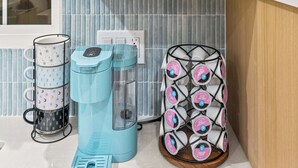 A kitchen with a wooden cabinet, a coffee maker, a mug holder, and a glass rack. - Anaheim, 2BR, modern guesthouse, Disneyland, sleeps 7, private entry & parking. (Anaheim)