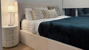 A modern bedroom with a bed, bedside tables, and artwork on the wall. - Fully Furnished Stylish Vaughan Condo near / Steps to VaughanMills (Vaughan)