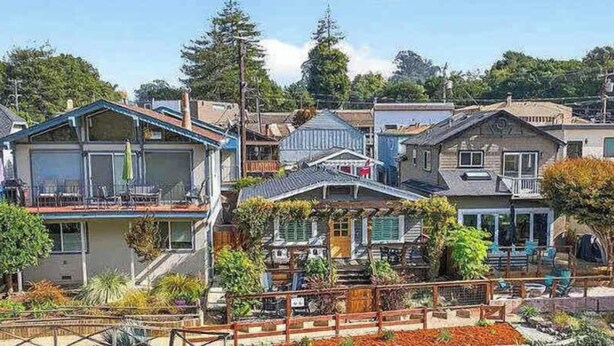 A residential area with houses featuring balconies, some with plants, and a mix of architectural styles. - Coastal Retreat in the Heart of Capitola Village - Steps from the Beach! (Capitola)
