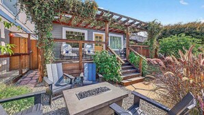 A patio with outdoor seating, a fire pit, and a pergola. - Coastal Retreat in the Heart of Capitola Village - Steps from the Beach! (Capitola)