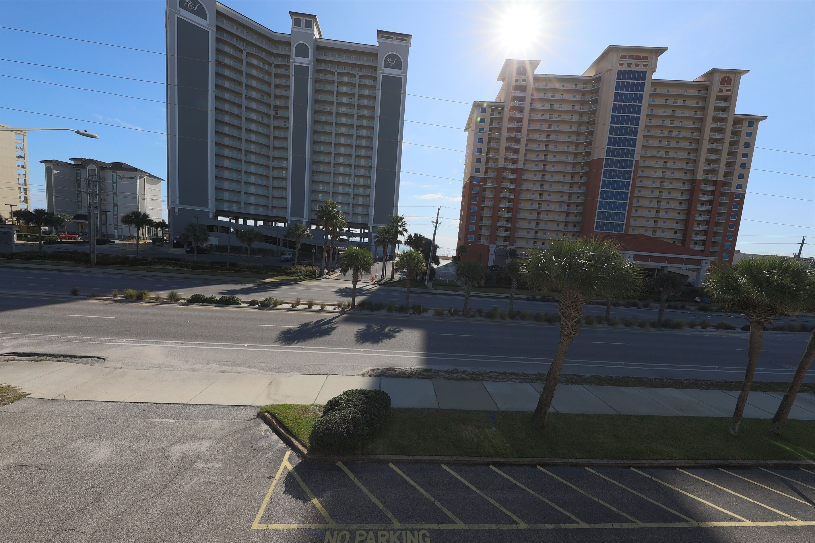 A multi-story hotel with a modern design, featuring a prominent vertical glass facade and a flat roof.