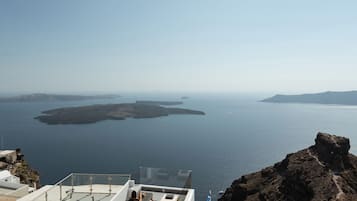 A rooftop pool with a view of the sea and islands.